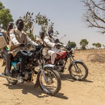 Four people sat on bikes in Africa